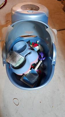 Cat litter box with air filter, toys, and food bowl