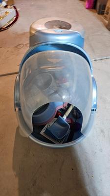 Cat litter box with air filter, toys, and food bowl