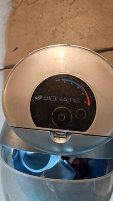 Cat litter box with air filter, toys, and food bowl