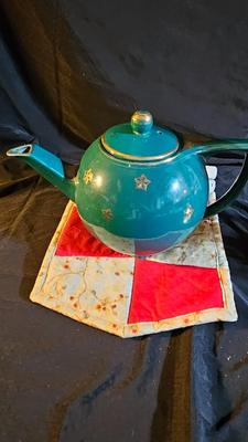 Hall tea pot with pillar candles and brass butterfly