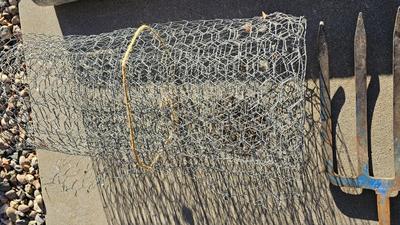 New roll 48" Hex netting fence with pitchfork and shovel heads