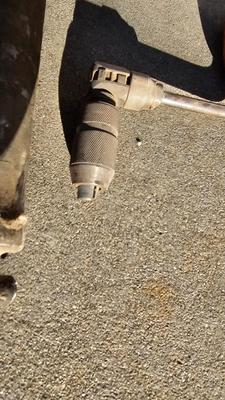 Vintage wood handled drill with drill bits and an old grease gun