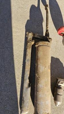 Vintage wood handled drill with drill bits and an old grease gun