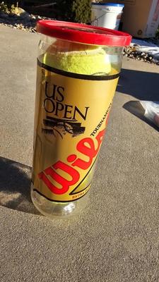 Two tennis racquets with tennis balls