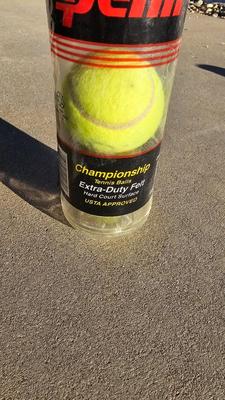 Two tennis racquets with tennis balls