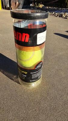 Two tennis racquets with tennis balls