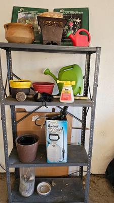 Metal shelf with planter pots weed sprayer, handcrafted plant rooters and more gardening items