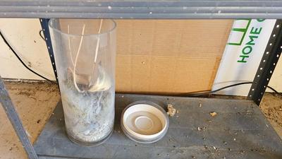 Metal shelf with planter pots weed sprayer, handcrafted plant rooters and more gardening items