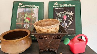 Metal shelf with planter pots weed sprayer, handcrafted plant rooters and more gardening items