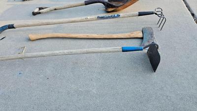 Snow shovels with garden tools and an axe