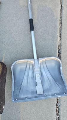 Snow shovels with garden tools and an axe