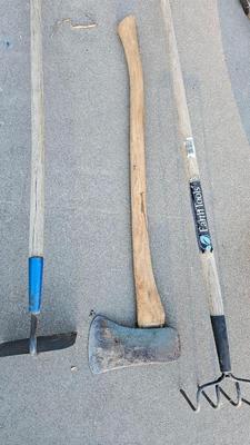 Snow shovels with garden tools and an axe