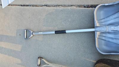 Snow shovels with garden tools and an axe