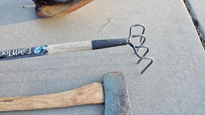 Snow shovels with garden tools and an axe