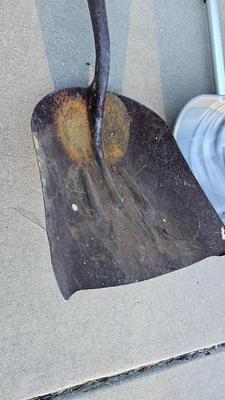 Snow shovels with garden tools and an axe