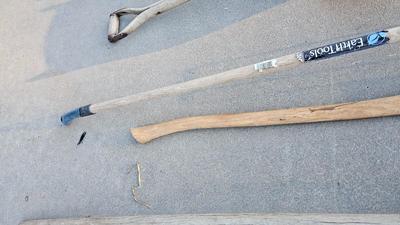 Snow shovels with garden tools and an axe