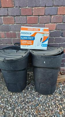 Trash cans with lids and a box of jumbo marathon 2-ply toilet paper