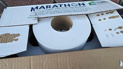 Trash cans with lids and a box of jumbo marathon 2-ply toilet paper