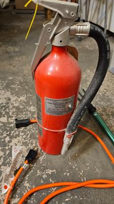 Extended Light bulb changer pole, extension cord and fire extinguisher