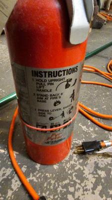 Extended Light bulb changer pole, extension cord and fire extinguisher