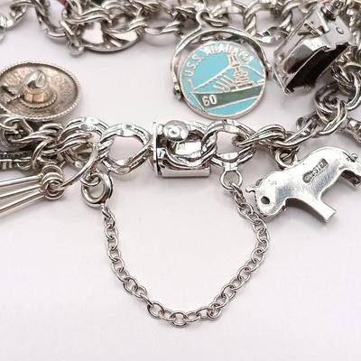 LOT 34: Vintage Sterling Silver Charm Bracelet Featuring 22 Charms and a Safety Chain 67.9gtw