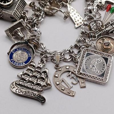 LOT 34: Vintage Sterling Silver Charm Bracelet Featuring 22 Charms and a Safety Chain 67.9gtw