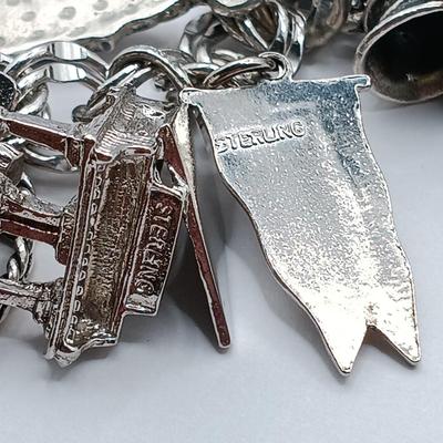 LOT 34: Vintage Sterling Silver Charm Bracelet Featuring 22 Charms and a Safety Chain 67.9gtw