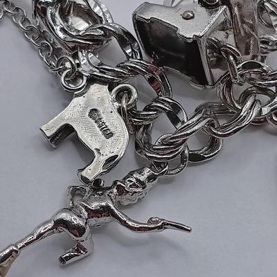 LOT 34: Vintage Sterling Silver Charm Bracelet Featuring 22 Charms and a Safety Chain 67.9gtw