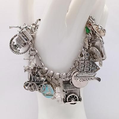 LOT 34: Vintage Sterling Silver Charm Bracelet Featuring 22 Charms and a Safety Chain 67.9gtw