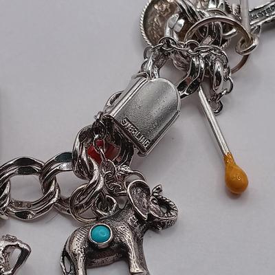 LOT 34: Vintage Sterling Silver Charm Bracelet Featuring 22 Charms and a Safety Chain 67.9gtw
