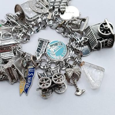 LOT 34: Vintage Sterling Silver Charm Bracelet Featuring 22 Charms and a Safety Chain 67.9gtw