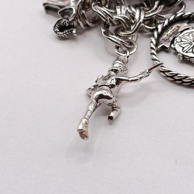 LOT 34: Vintage Sterling Silver Charm Bracelet Featuring 22 Charms and a Safety Chain 67.9gtw