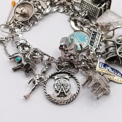 LOT 34: Vintage Sterling Silver Charm Bracelet Featuring 22 Charms and a Safety Chain 67.9gtw