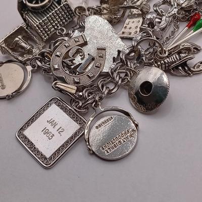 LOT 34: Vintage Sterling Silver Charm Bracelet Featuring 22 Charms and a Safety Chain 67.9gtw