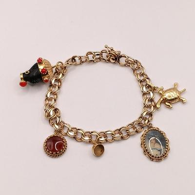LOT 35: 14K Gold Charm Bracelet w/ 18K Corletto Blackamoor Pendant, 14K Carnelian Charm, 14K Handpainted Lady &Bead. 22.7gtw