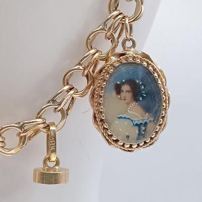 LOT 35: 14K Gold Charm Bracelet w/ 18K Corletto Blackamoor Pendant, 14K Carnelian Charm, 14K Handpainted Lady &Bead. 22.7gtw