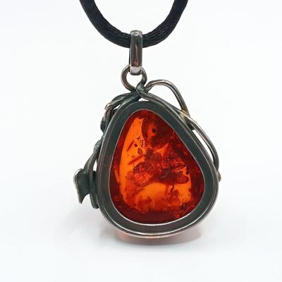 LOT 254: Baltic Amber and Sterling 2" Pendant on Silk Cord with Sterling and Amber Earrings