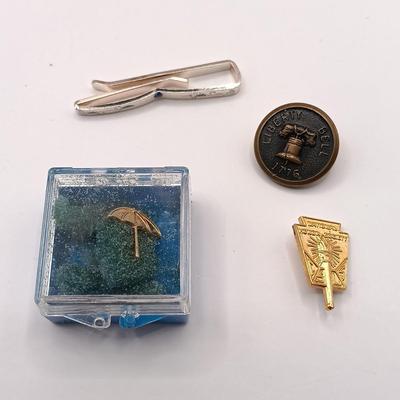 LOT 257: Etienne Aigner Designer Pen, Philadelphia Gas Works Sterling Pendant and Pin, World's Fair Ford Motor Clip & More