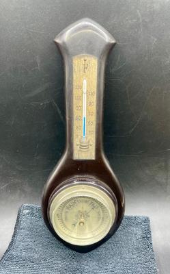 Sale Photo Thumbnail #311: Thermometer and barometer in a beautiful Mahogany case. Working condition. Approx. 11" tall. For hanging on a wall. Age unknown, possibly made in West Germany.