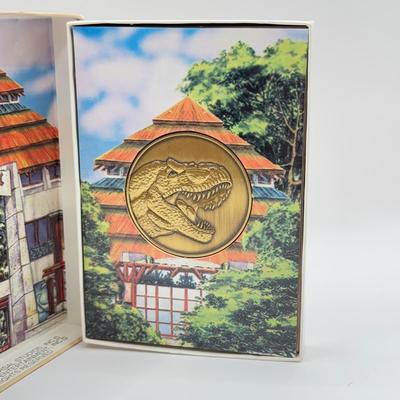 LOT 116J: 1999 Universal Studios Islands of Adventure Jurassic Park Dinosaur Coin Medallion in Original Box