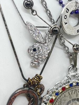 LOT 183J: Eclectic Silvertone Necklace Collection: Playboy Bunny, Rod Stewart, Liberty Bell and More