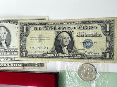 LOT 221J: US Currency Collection: 1957 $1 Silver Certificate, 1980 Susan B. Anthony Souvenir Set, 1997 Coin Set, Bag of Wheat Pennies