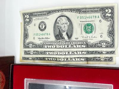 LOT 221J: US Currency Collection: 1957 $1 Silver Certificate, 1980 Susan B. Anthony Souvenir Set, 1997 Coin Set, Bag of Wheat Pennies