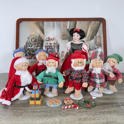 LOT 301B: Vintage Retired Disney Christmas Snow White and the Seven Dwarfs Ashton Drake Galleries Porcelain Dolls w/ Wooden Backdrop
