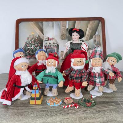 LOT 301B: Vintage Retired Disney Christmas Snow White and the Seven Dwarfs Ashton Drake Galleries Porcelain Dolls w/ Wooden Backdrop