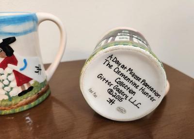 Lot #147 Pair of Clementine Hunter Mugs - "Cotton Picking" and "A Day at Melrose Plantation"
