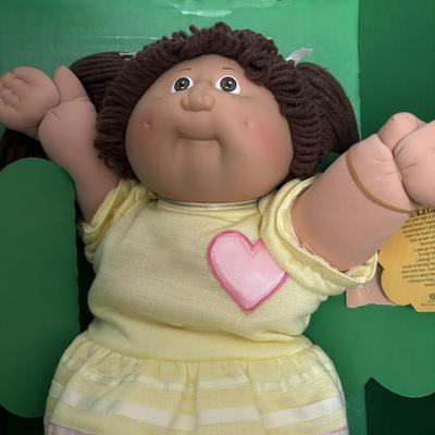 LOT 11: Adorable Cabbage Patch Doll with Adoption Papers and Baby Sinclair Talking Dinosaur (see pictures)
