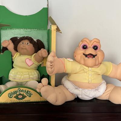 LOT 11: Adorable Cabbage Patch Doll with Adoption Papers and Baby Sinclair Talking Dinosaur (see pictures)