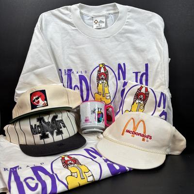 LOT 148: Vintage Ronald Mcdonald T-Shirts (qty of 3, XL), 3 Hats and a Plastic Coffee Mug w/Lid