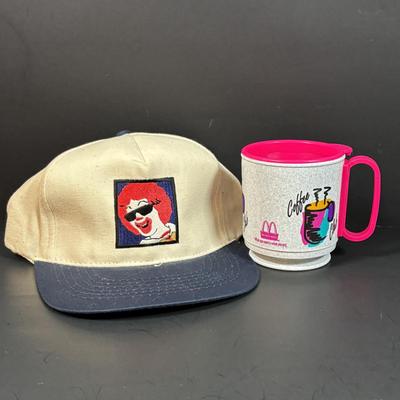 LOT 148: Vintage Ronald Mcdonald T-Shirts (qty of 3, XL), 3 Hats and a Plastic Coffee Mug w/Lid